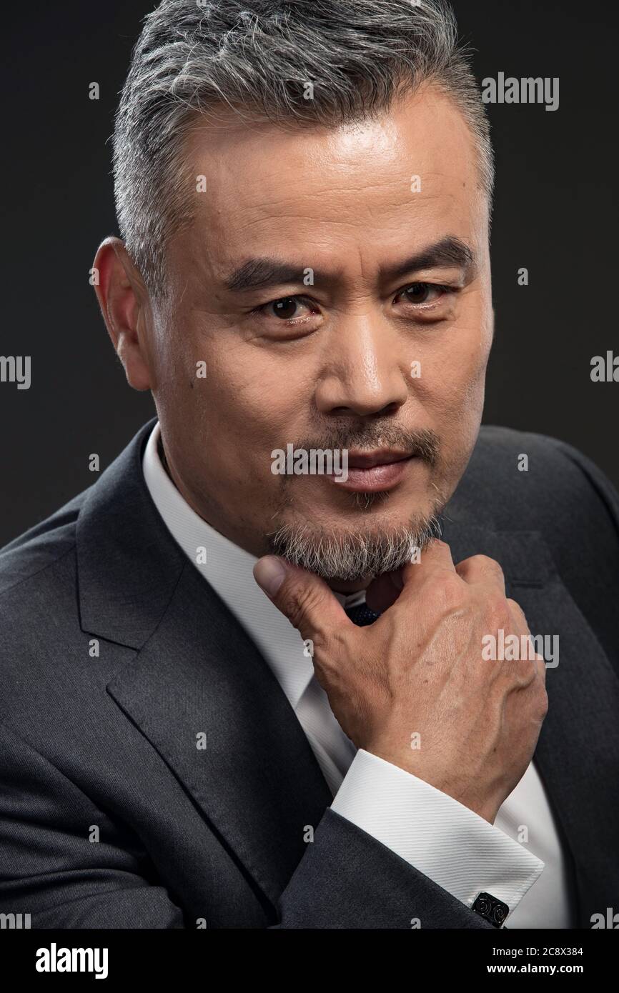 Man touching chin fingers hi-res stock photography and images - Alamy