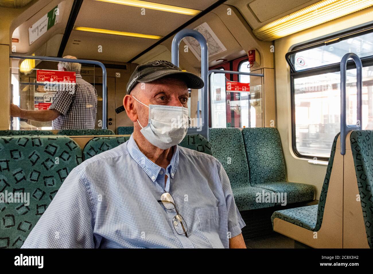 Senior elderly man wearing face mask on public transport during