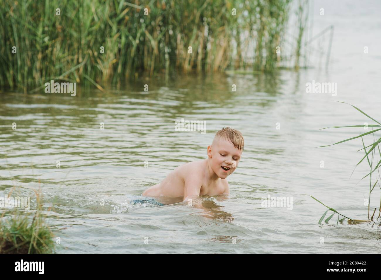 Boy diving into lake hi-res stock photography and images - Alamy