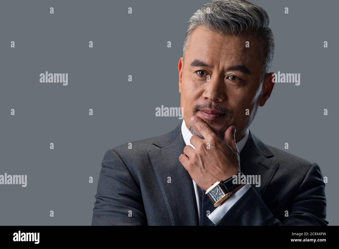 Head shot thinking touching chin hi-res stock photography and images ...