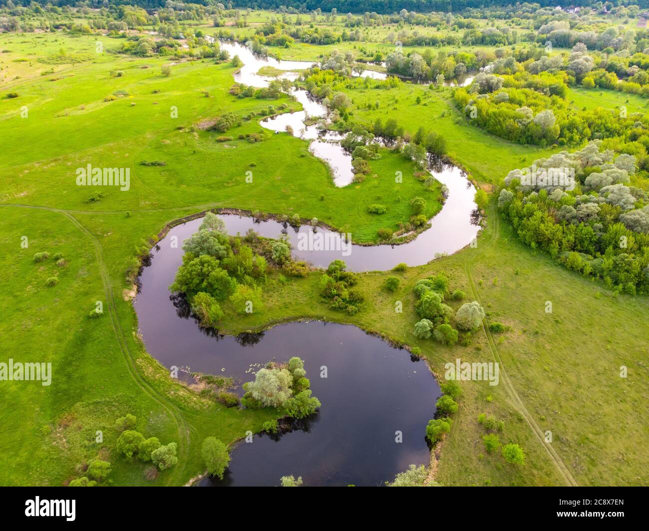 aerial drone landscape of river in green field, top view of beautiful nature texture from drone Stock Photo