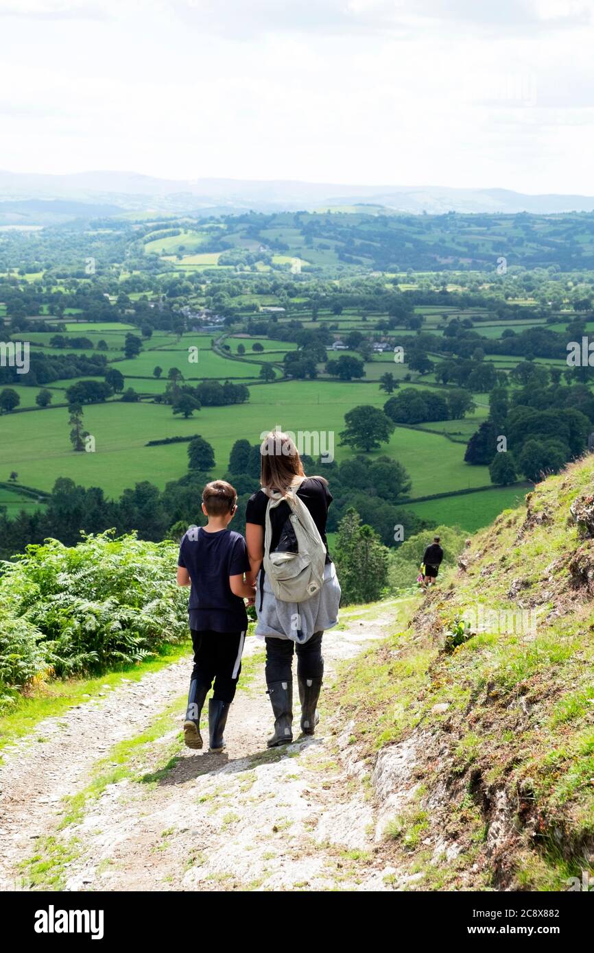 Rear view of people walking in the countryside after Covid 19 lockdown is eased in summer July 2020 Carmarthenshire Wales UK. KATHY DEWITT Stock Photo