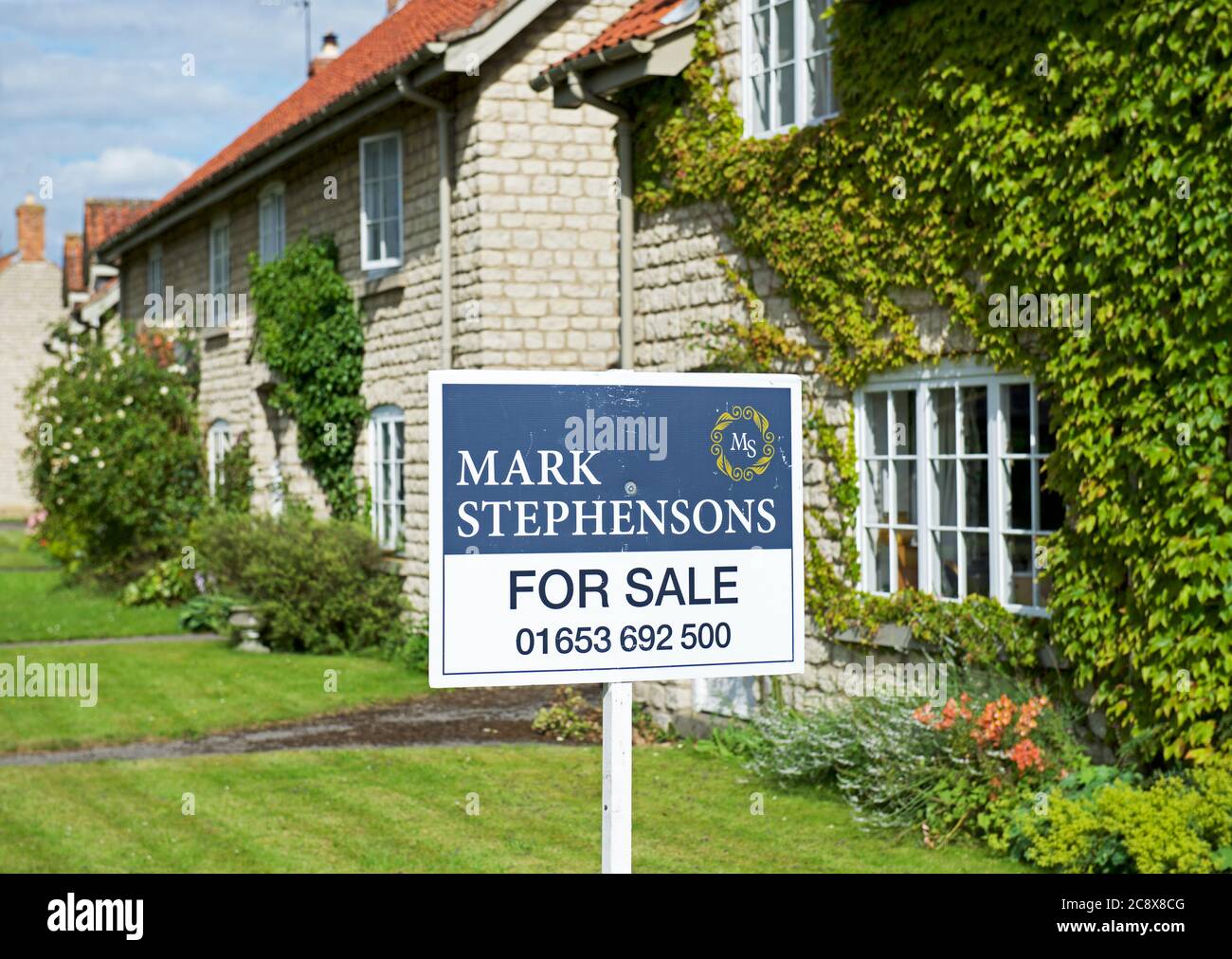 House for sale sign in the village of Hovingham, Ryedale, North