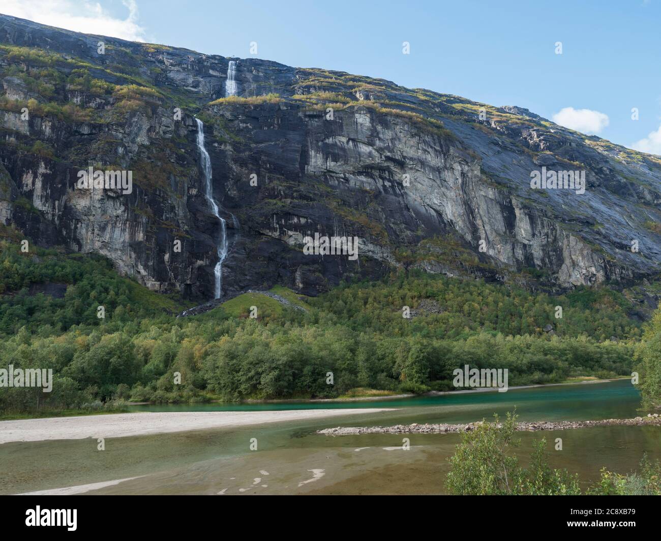Tall waterfall with turquoise Rauma river at Romsdalen valley with ...