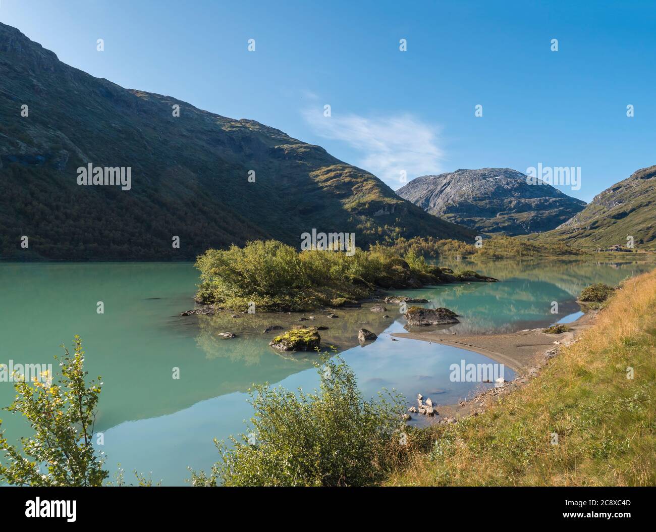 Milky blue glacial water of Lake Bovertunvatnet in the Jotunheimen National Park, Norway. Early autumn blue sky background. Stock Photo