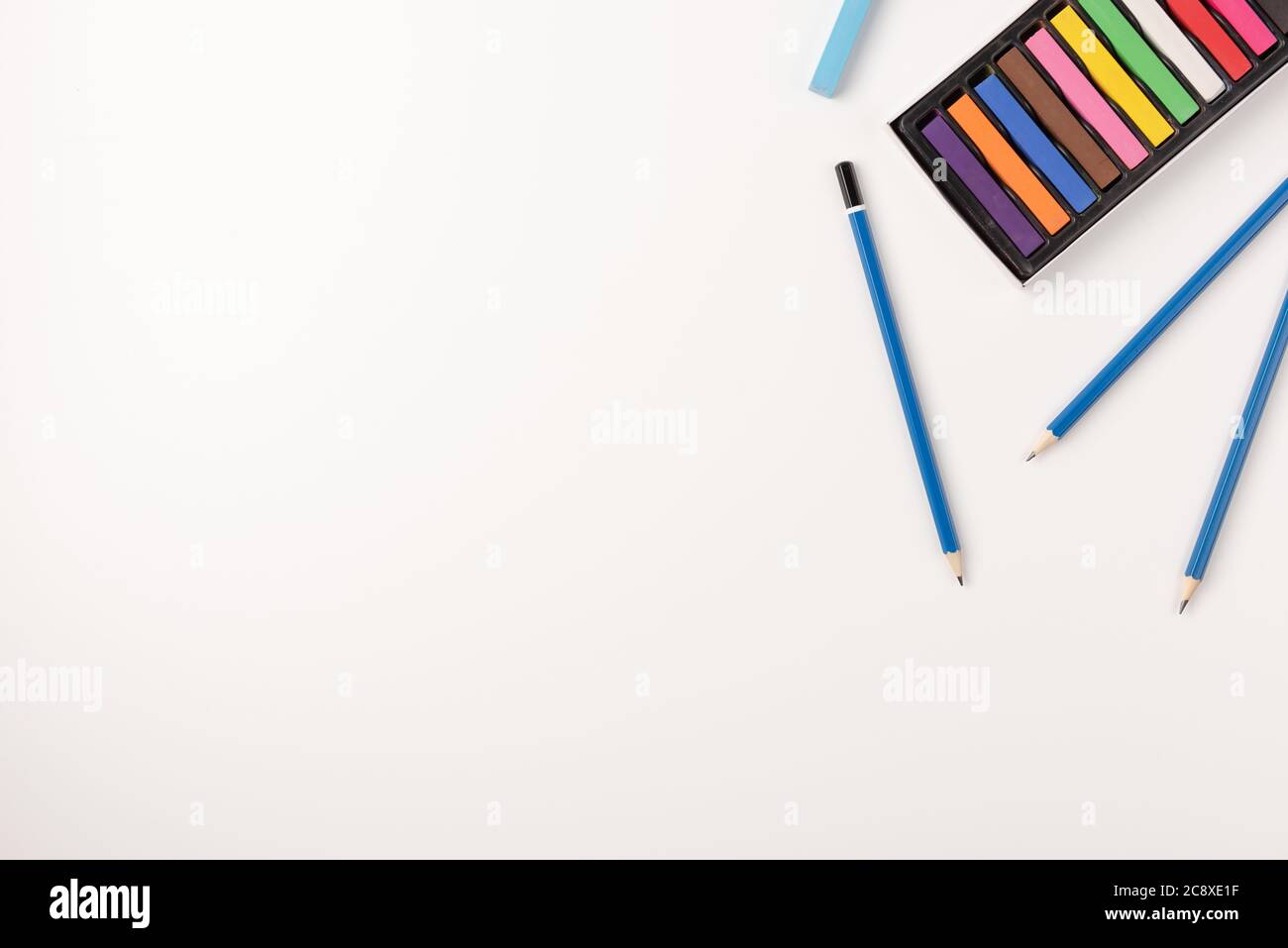 Colorful wax crayons and pencils isolated on white background. Copy ...