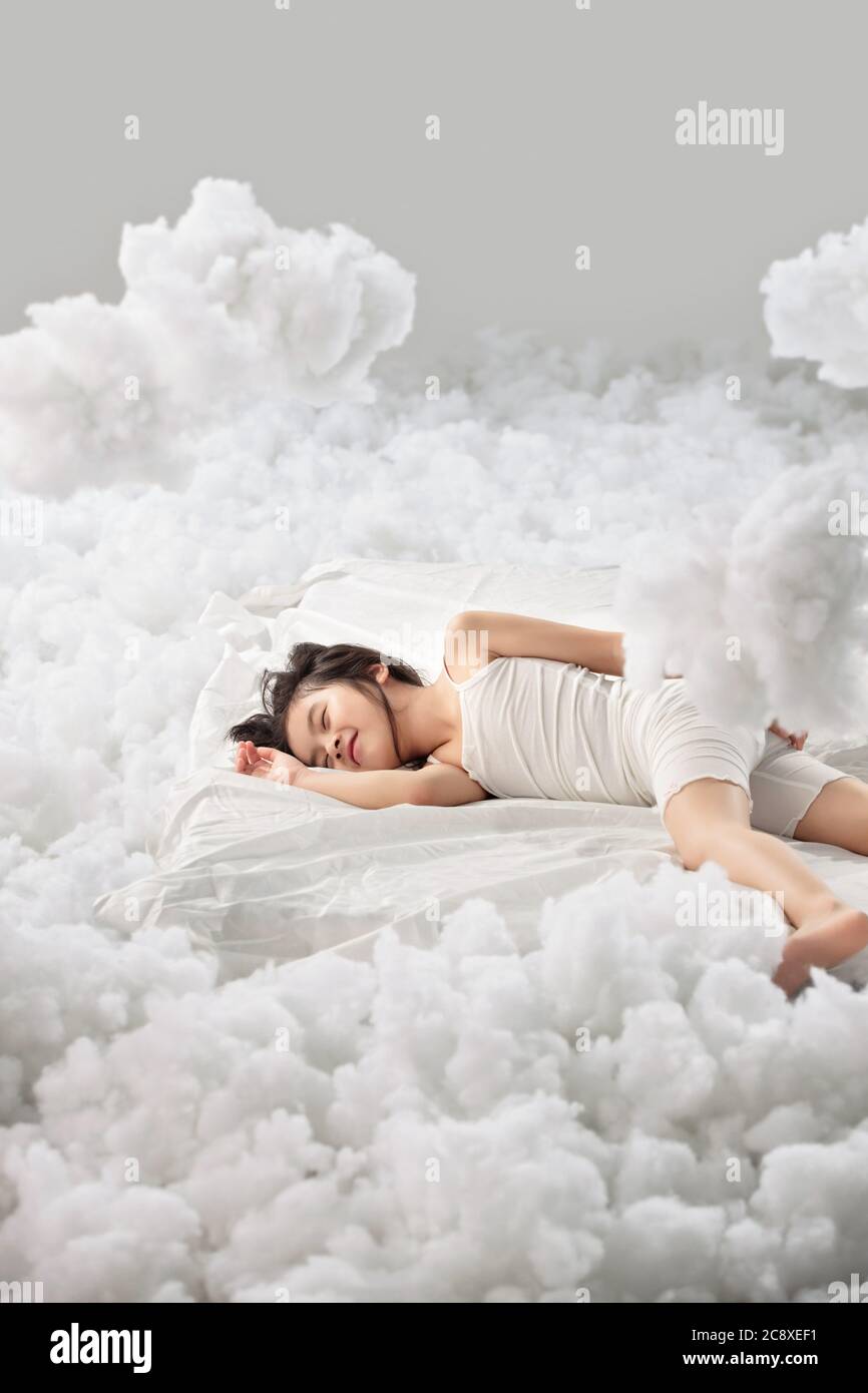 Lovely little girl lying on the cloud Stock Photo - Alamy