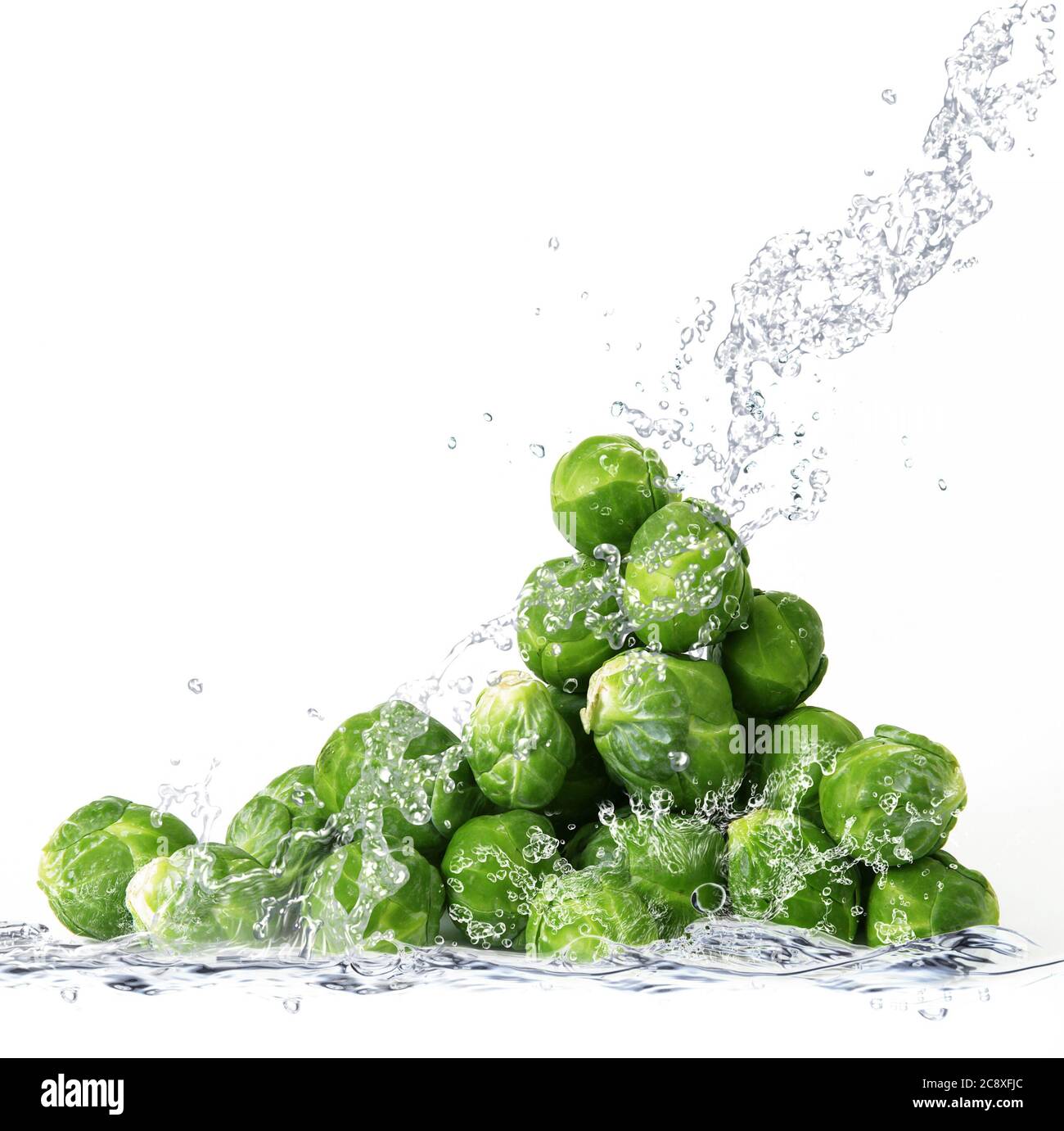 Fresh Brussels sprouts falling in pure water Stock Photo Alamy