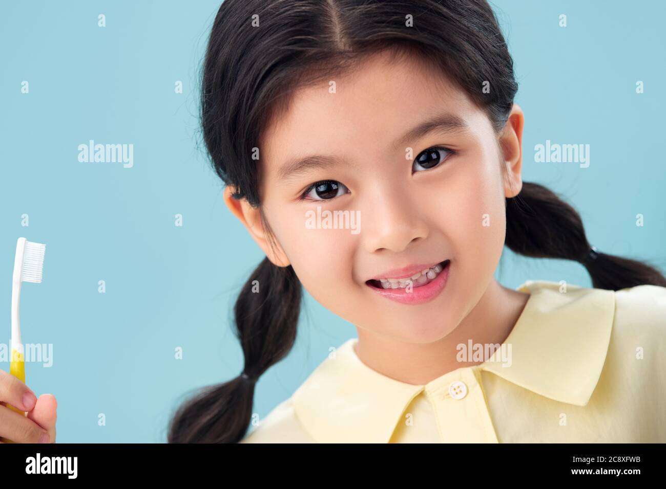 The little girl with a toothbrush Stock Photo