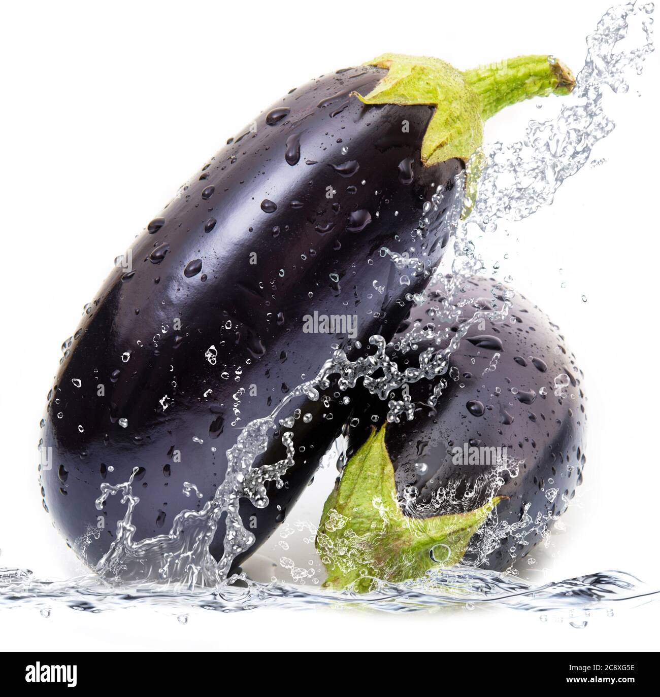 fresh aubergine falling in pure water Stock Photo