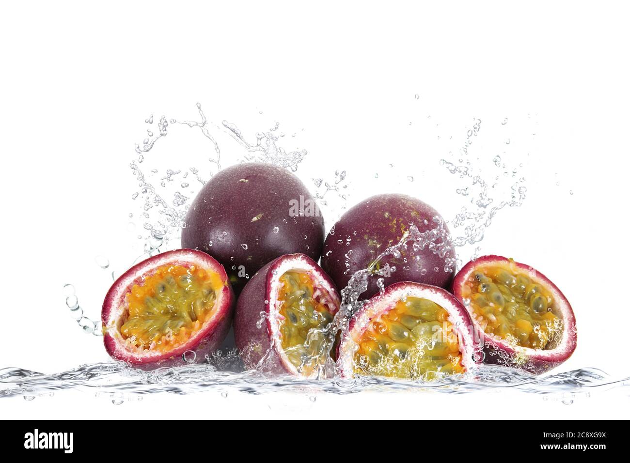 fresh passion fruit falling in water Stock Photo Alamy
