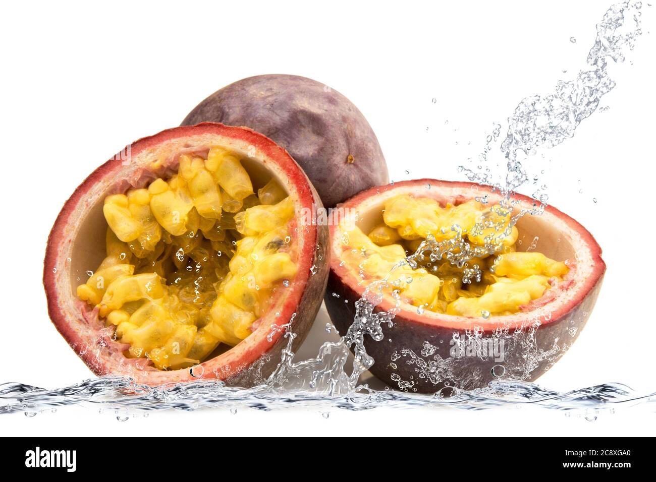 fresh passion fruit falling in water Stock Photo Alamy
