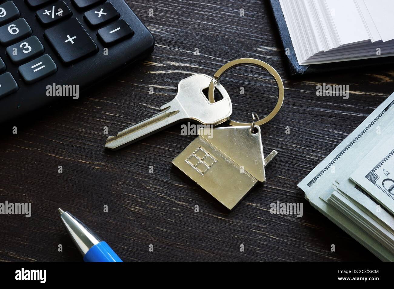 First time home buyer loan mortgage. Metal key and money. Stock Photo