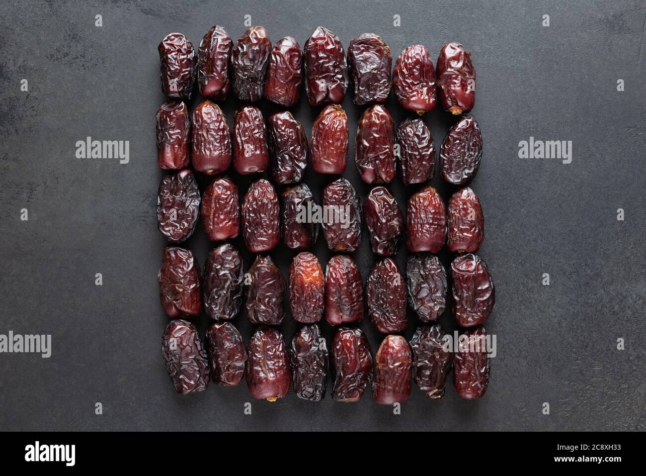 Dry Medjool Dates On Black Slate Background. Group of Dried Date Fruits