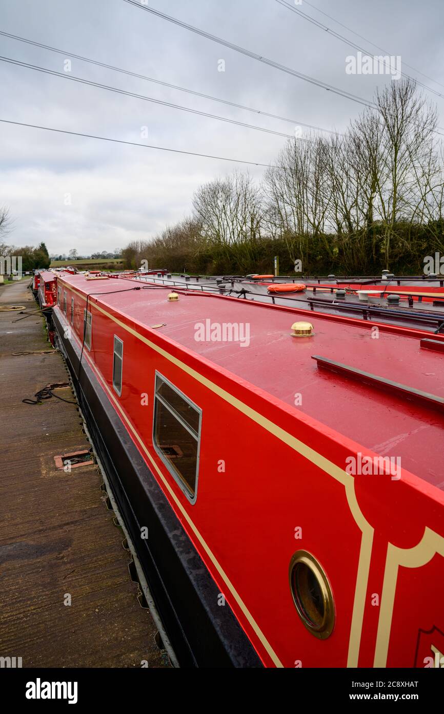 Red narrowboat Wait & See moored up at Whittington Wharf Shropshire. Stock Photo