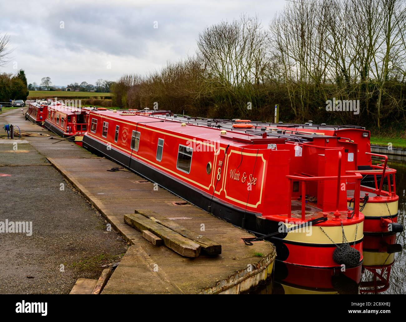 Red narrowboat Wait & See moored up at Whittington Wharf Shropshire. Stock Photo