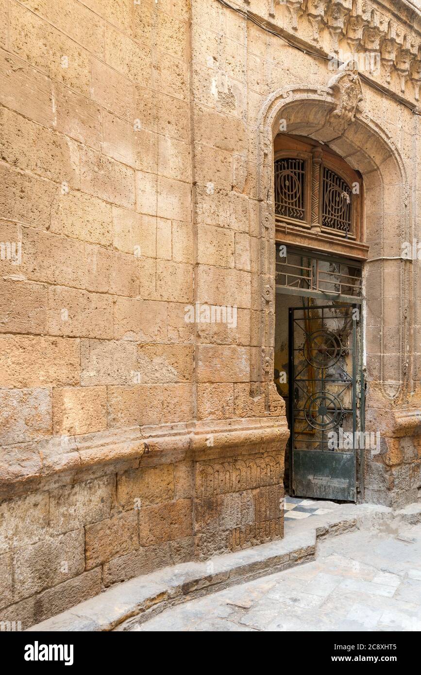 Angled view of grunge door with wrought iron grill on grunge