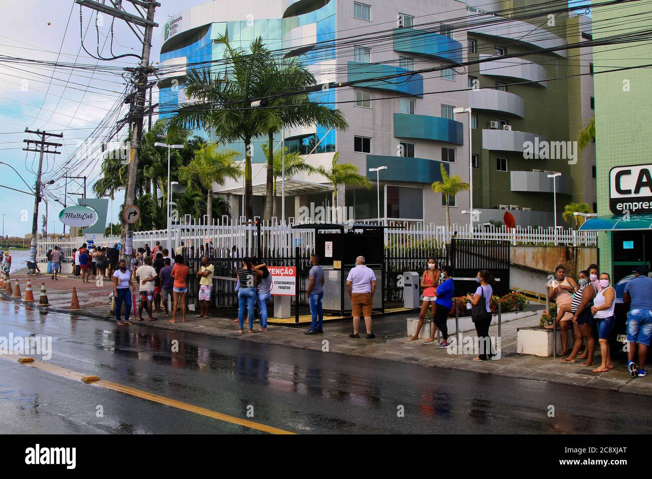 Salvador, Brazil. 27th July, 2020. Agglomeration and queue at the entrance of a bank branch of Caixa Econômica Federal, in the middle of the pandemic, in the neighborhood of Sussuarana, in Salvador, (BA). Credit: Mauro Akiin Nassor/FotoArena/Alamy Live News Stock Photo