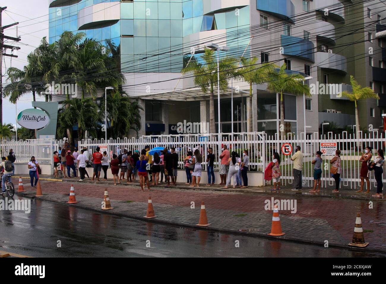 Salvador, Brazil. 27th July, 2020. Agglomeration and queue at the entrance of a bank branch of Caixa Econômica Federal, in the middle of the pandemic, in the neighborhood of Sussuarana, in Salvador, (BA). Credit: Mauro Akiin Nassor/FotoArena/Alamy Live News Stock Photo