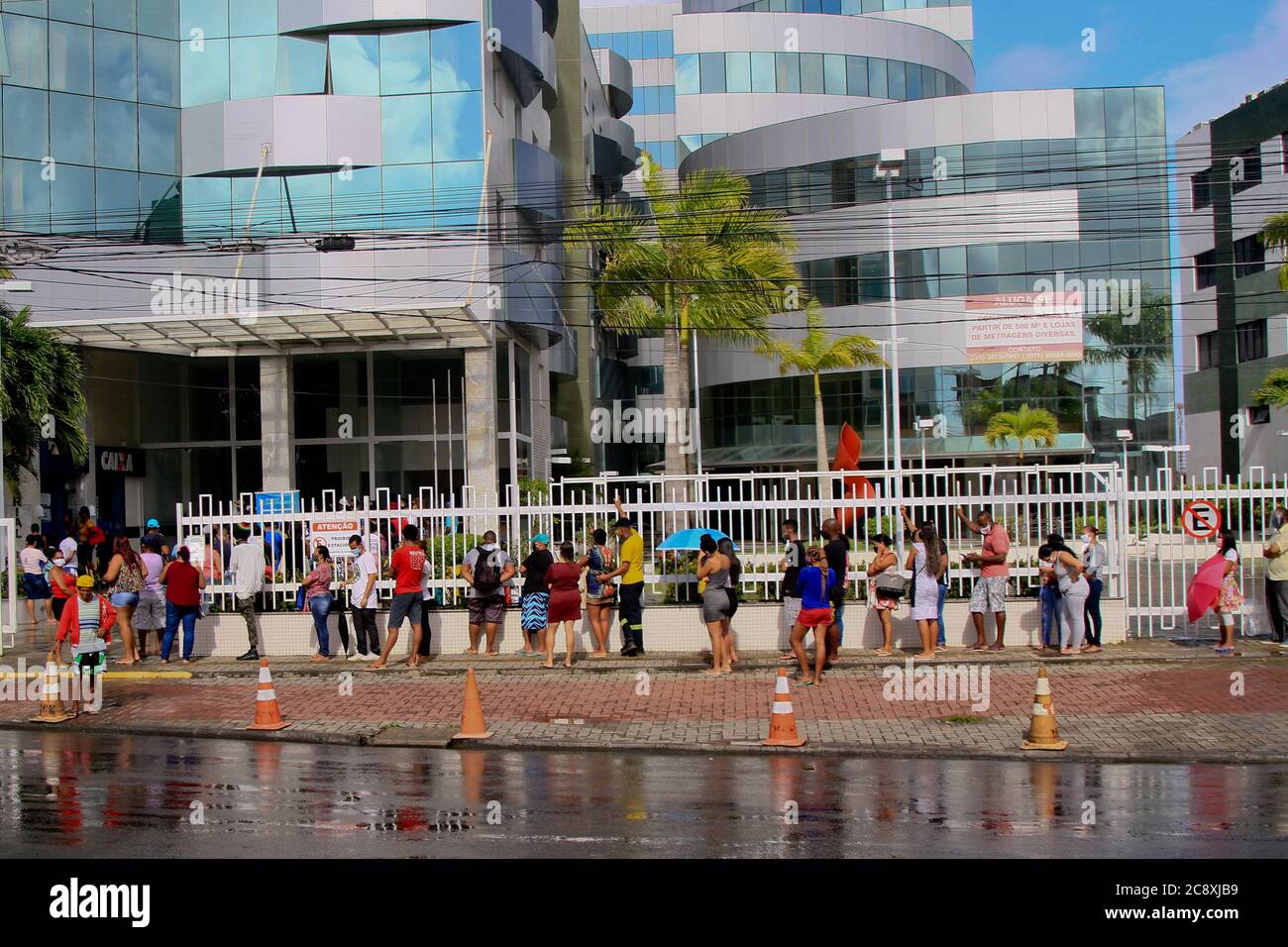 Salvador, Brazil. 27th July, 2020. Agglomeration and queue at the entrance of a bank branch of Caixa Econômica Federal, in the middle of the pandemic, in the neighborhood of Sussuarana, in Salvador, (BA). Credit: Mauro Akiin Nassor/FotoArena/Alamy Live News Stock Photo