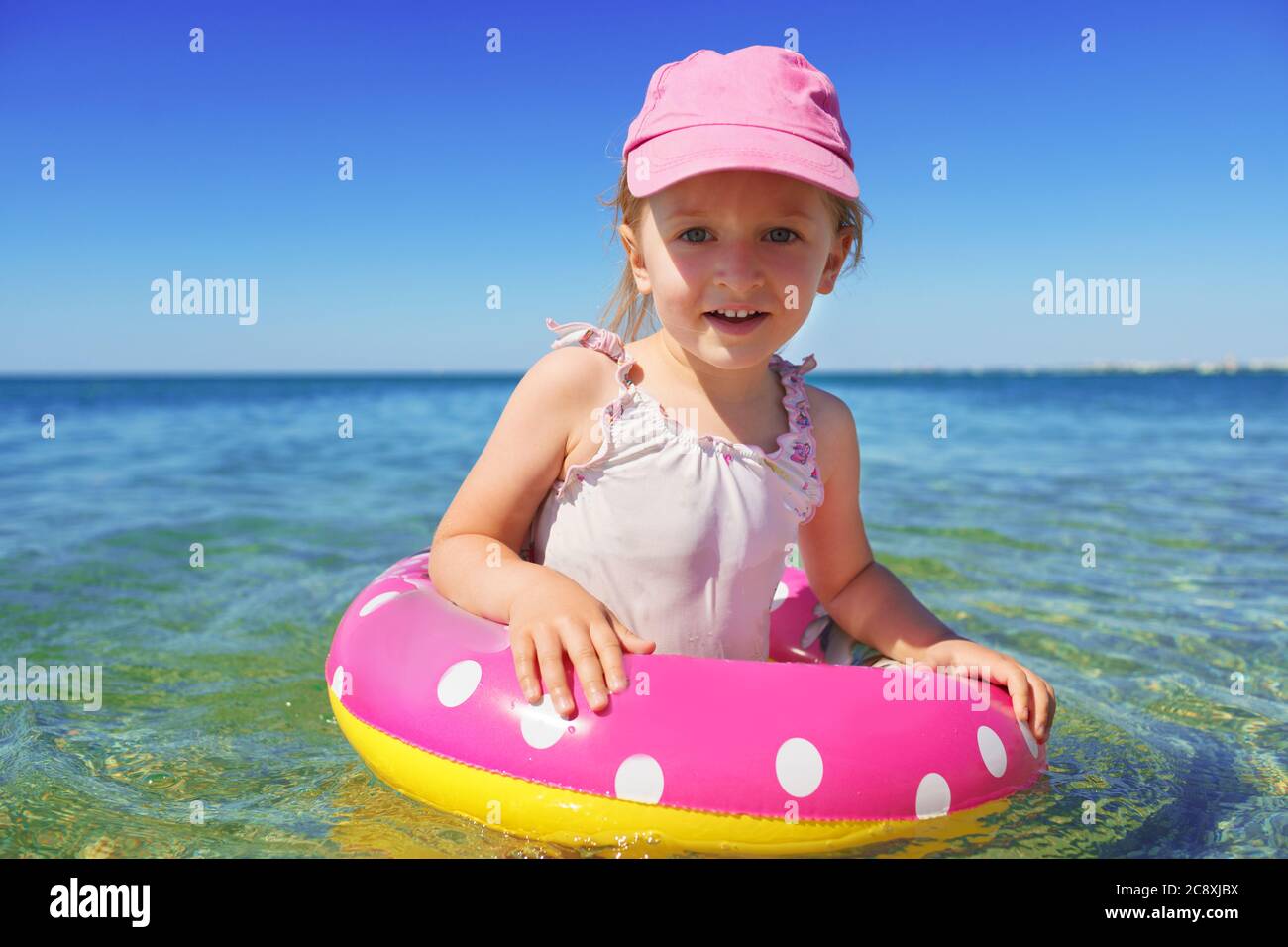 Little girl in bikini swimming in sea with swimming circle Stock Photo Alamy
