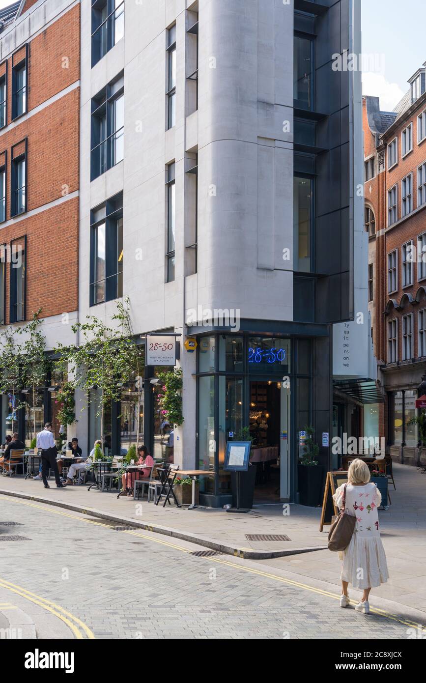 People seated at pavement tables dining al fresco at the 2850 Wine