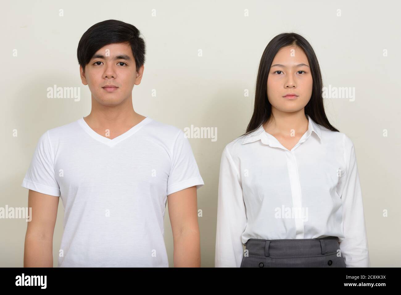 Portrait of young Asian couple together against white background Stock ...