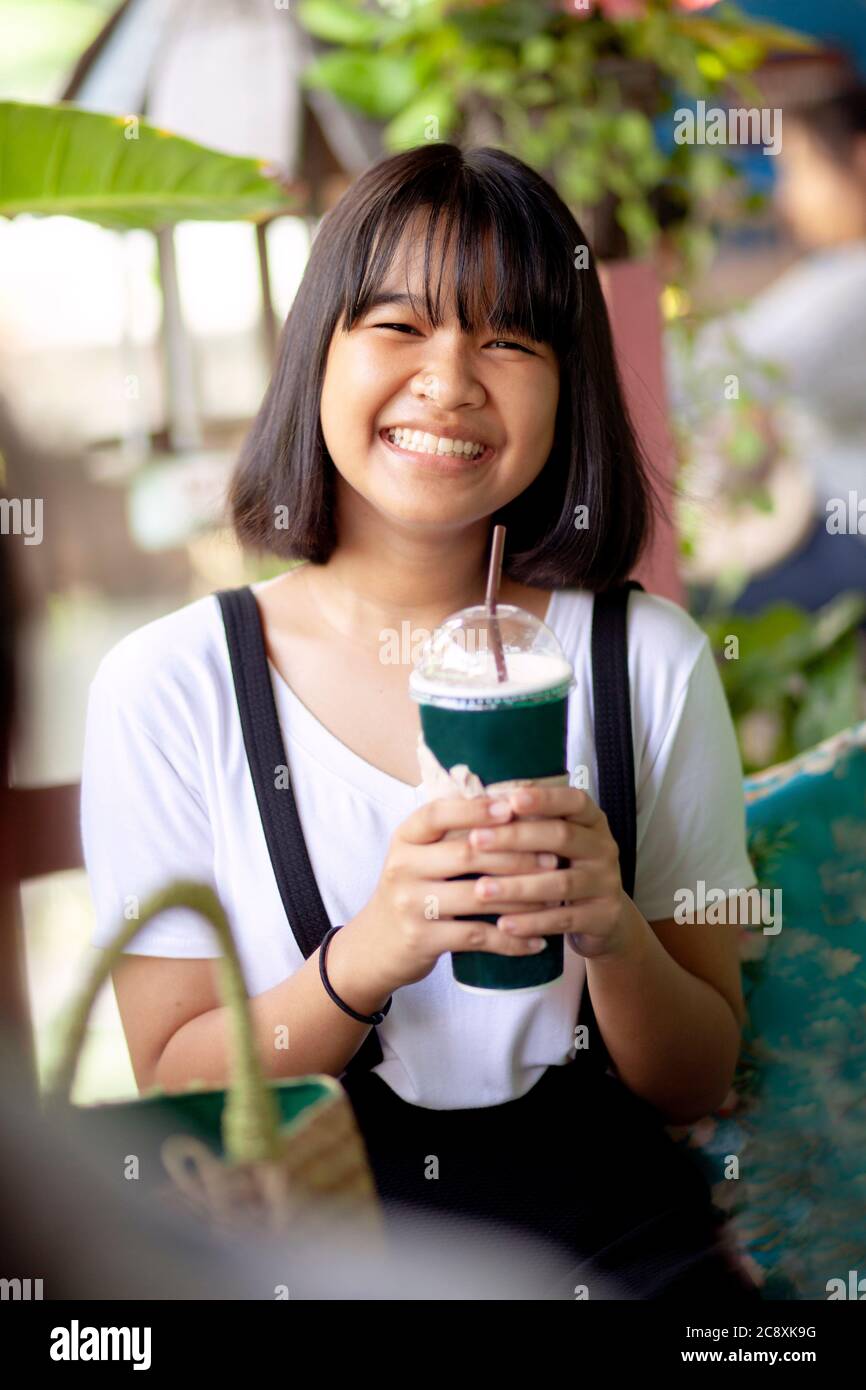 https://c8.alamy.com/comp/2C8XK9G/asian-teenager-happiness-face-with-cool-drink-bottle-in-hand-2C8XK9G.jpg