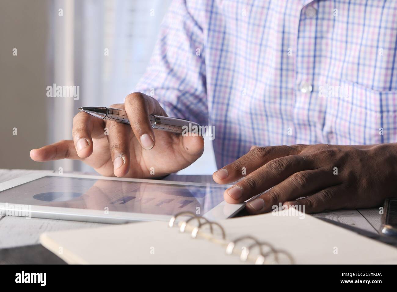 man's hand working on digital tablet at office desk, using self created ...