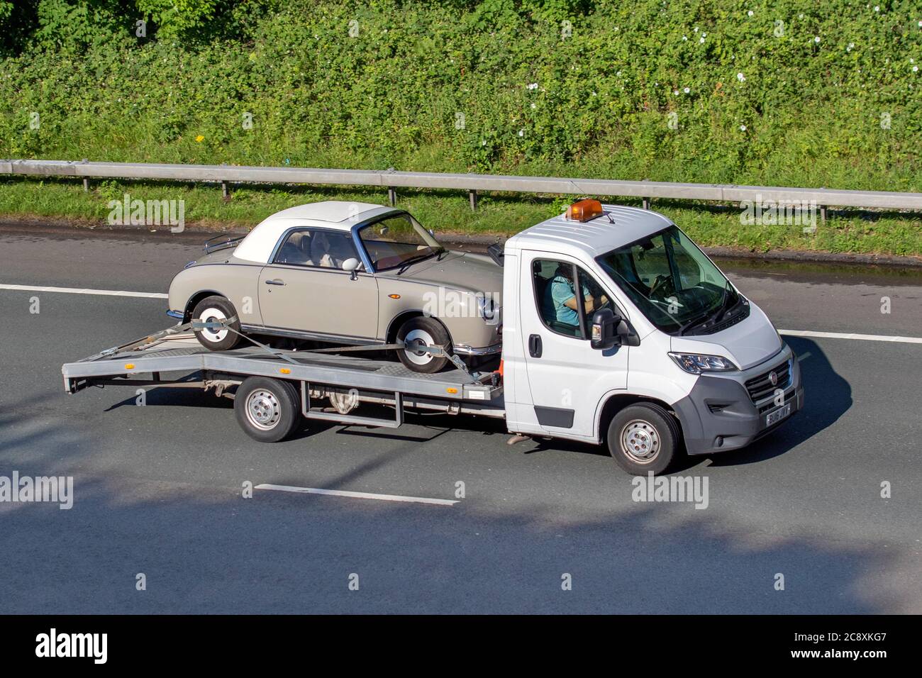 2016 Fiat Ducato 35 Multijet LWB S- low loader, car transport carrying veteran classic car, cherished veteran, restored old timer, collectible motors, vintage heritage, old preserved Nissan Figaro, collectable car on the m6 Motorway, UK Stock Photo