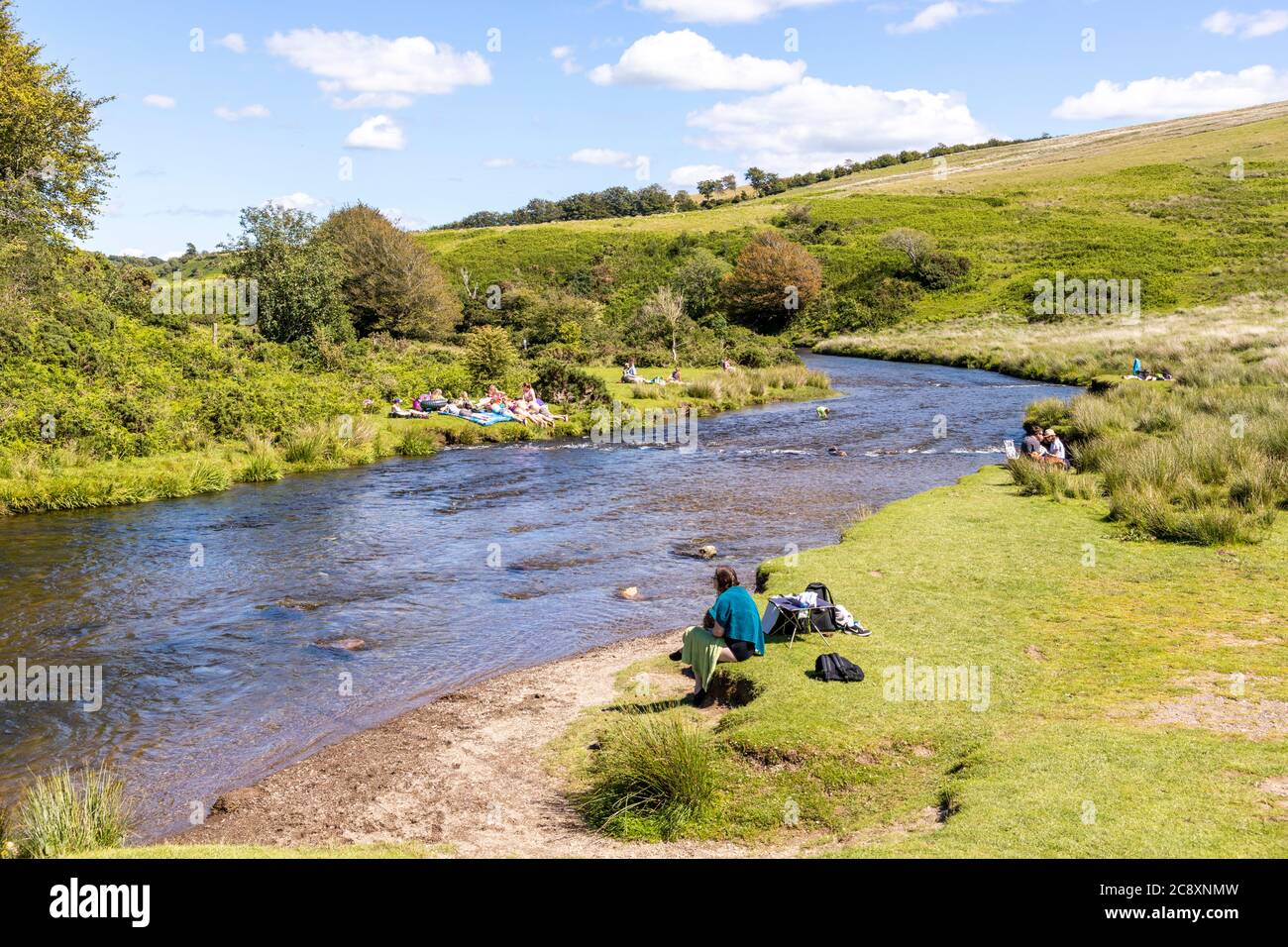 A sunny Saturday summer afternoon on Exmoor National Park beside the River Barle at Landacre Bridge near Withypool, Somerset UK Stock Photo
