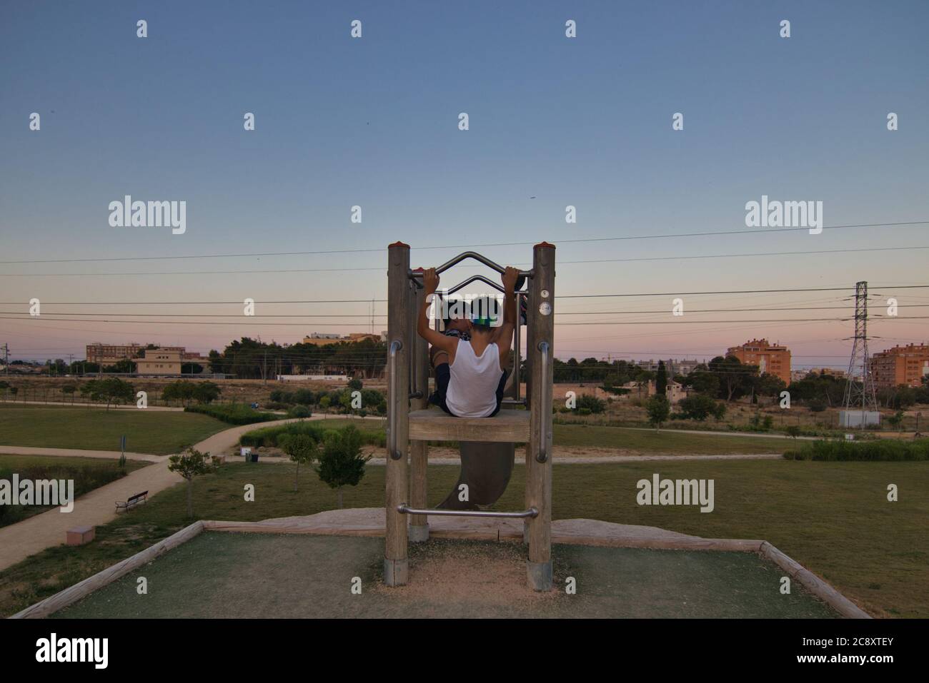 giant slide with blue sky and some kids playing Stock Photo