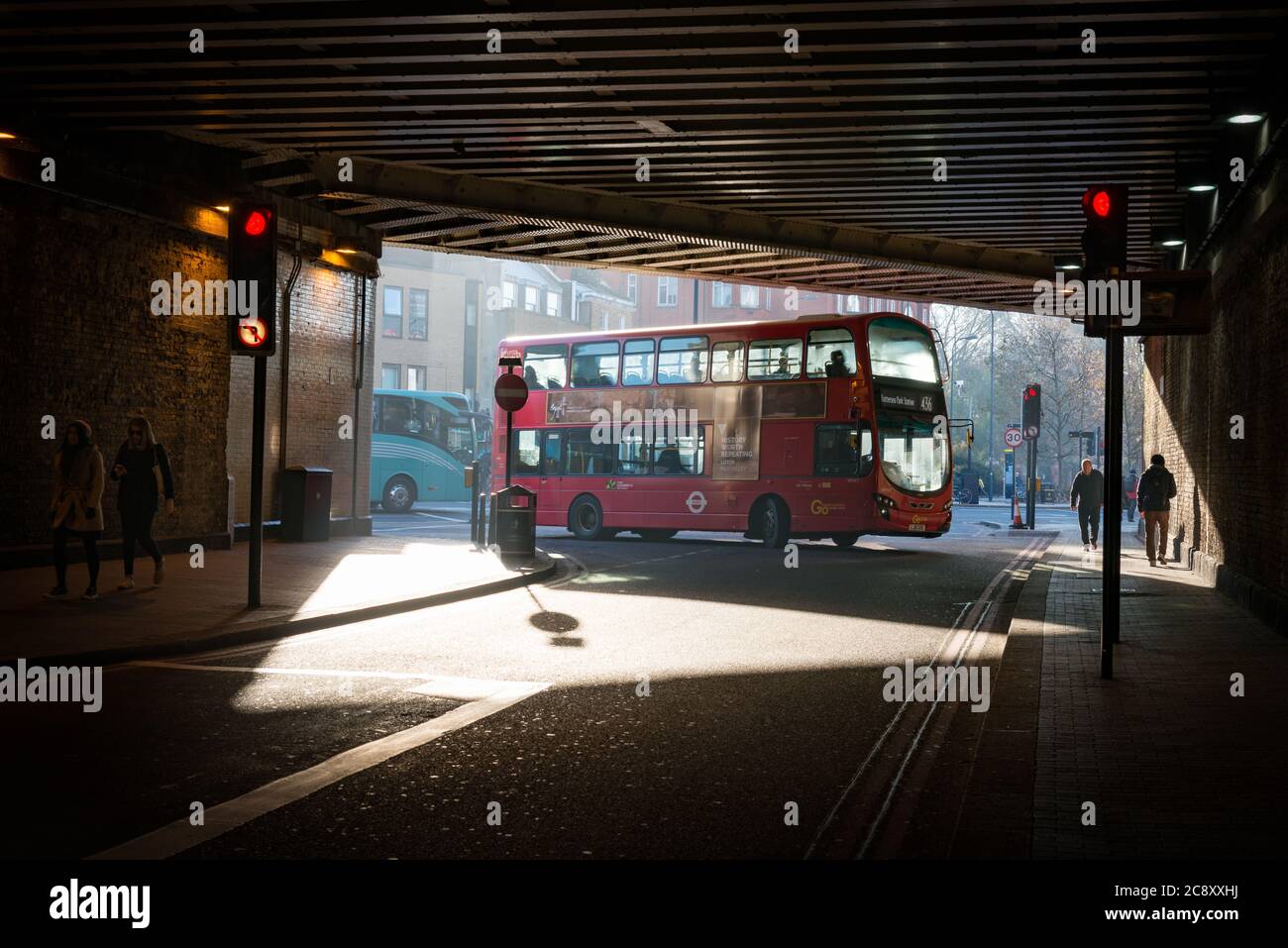 A red London bus going under Vauxhall bridge, London, UK Stock Photo