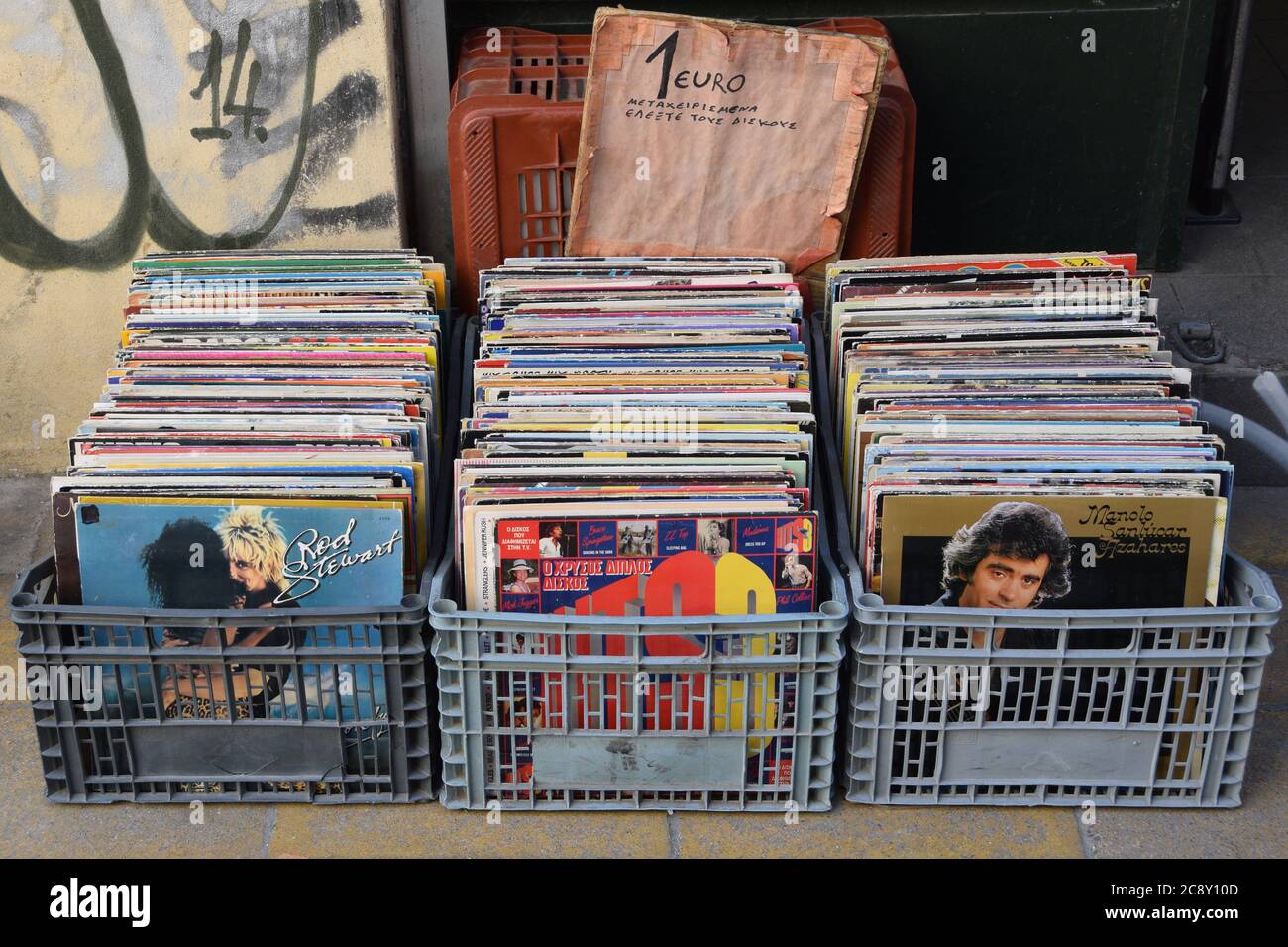 Athens, Greece - April 27, 2015: Plastic crates with used records at street market. Old vinyl albums one dollar bin with sign urging to check conditio Stock Photo