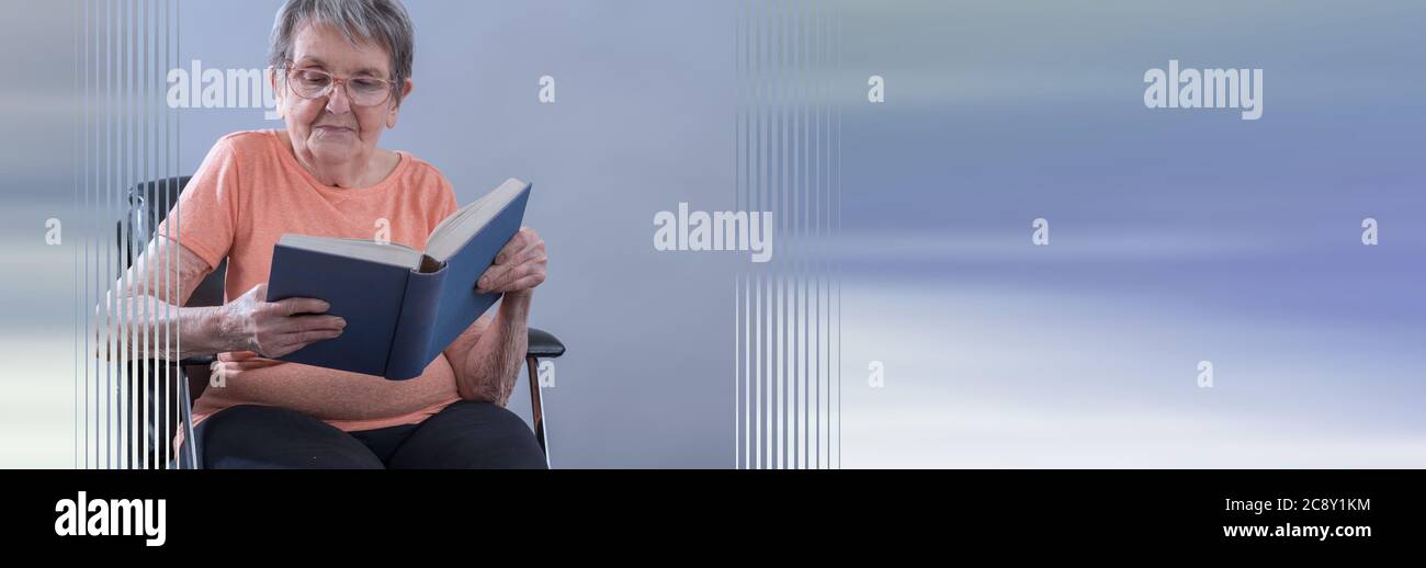 Senior woman sitting and reading a book; panoramic banner Stock Photo ...