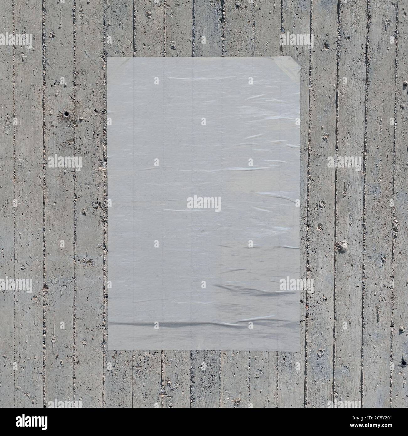 White crumpled paper wheatpaste poster on concrete wall background. Design element. Stock Photo