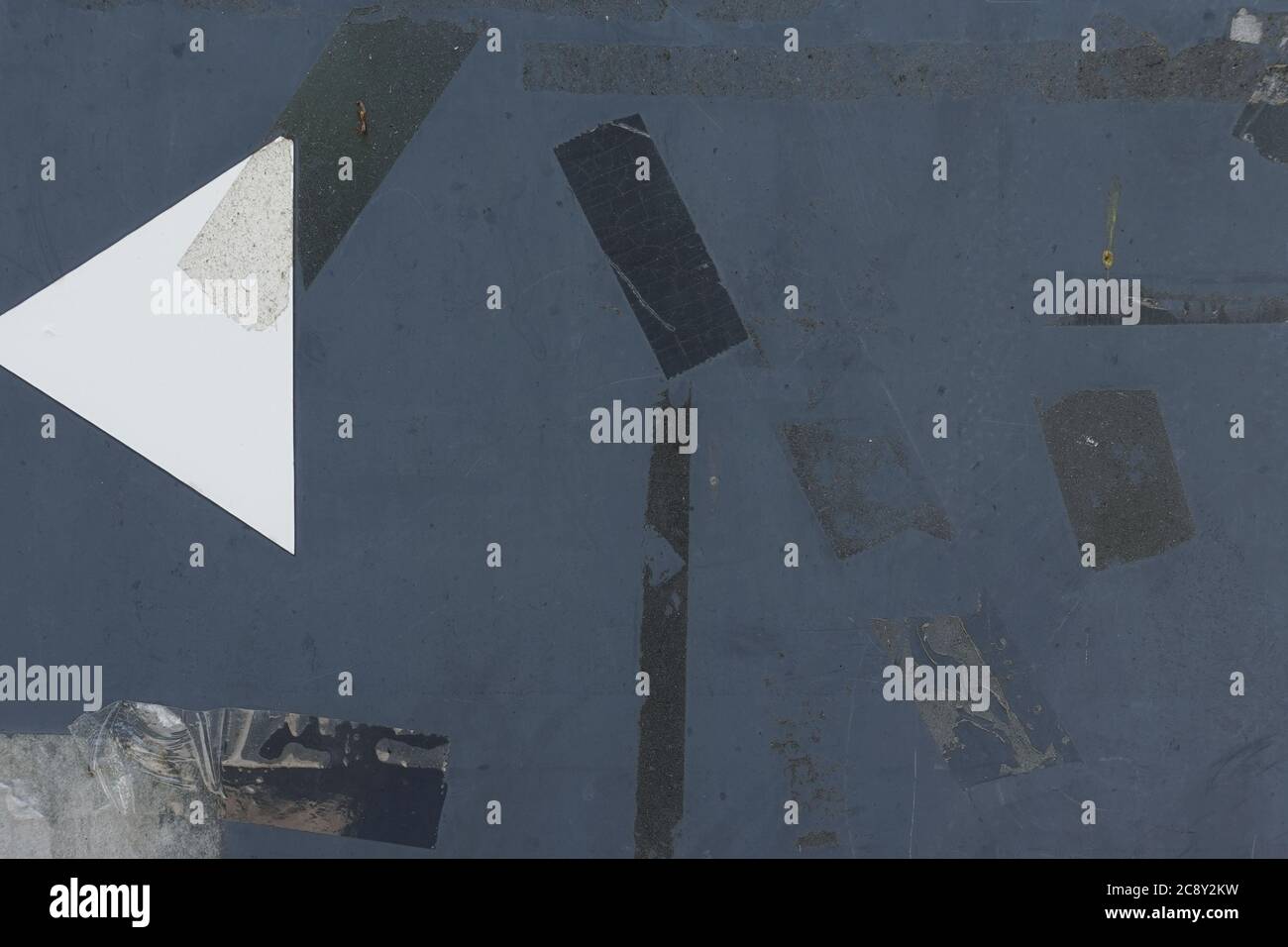 Adhesive tape stains and stickers on weathered metal surface. Abstract ...