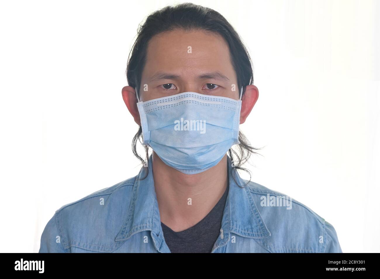 Man wearing a cloth mask protect himself from risk of disease, people prevent infection from coronavirus Covid-19 or Air pollution Stock Photo