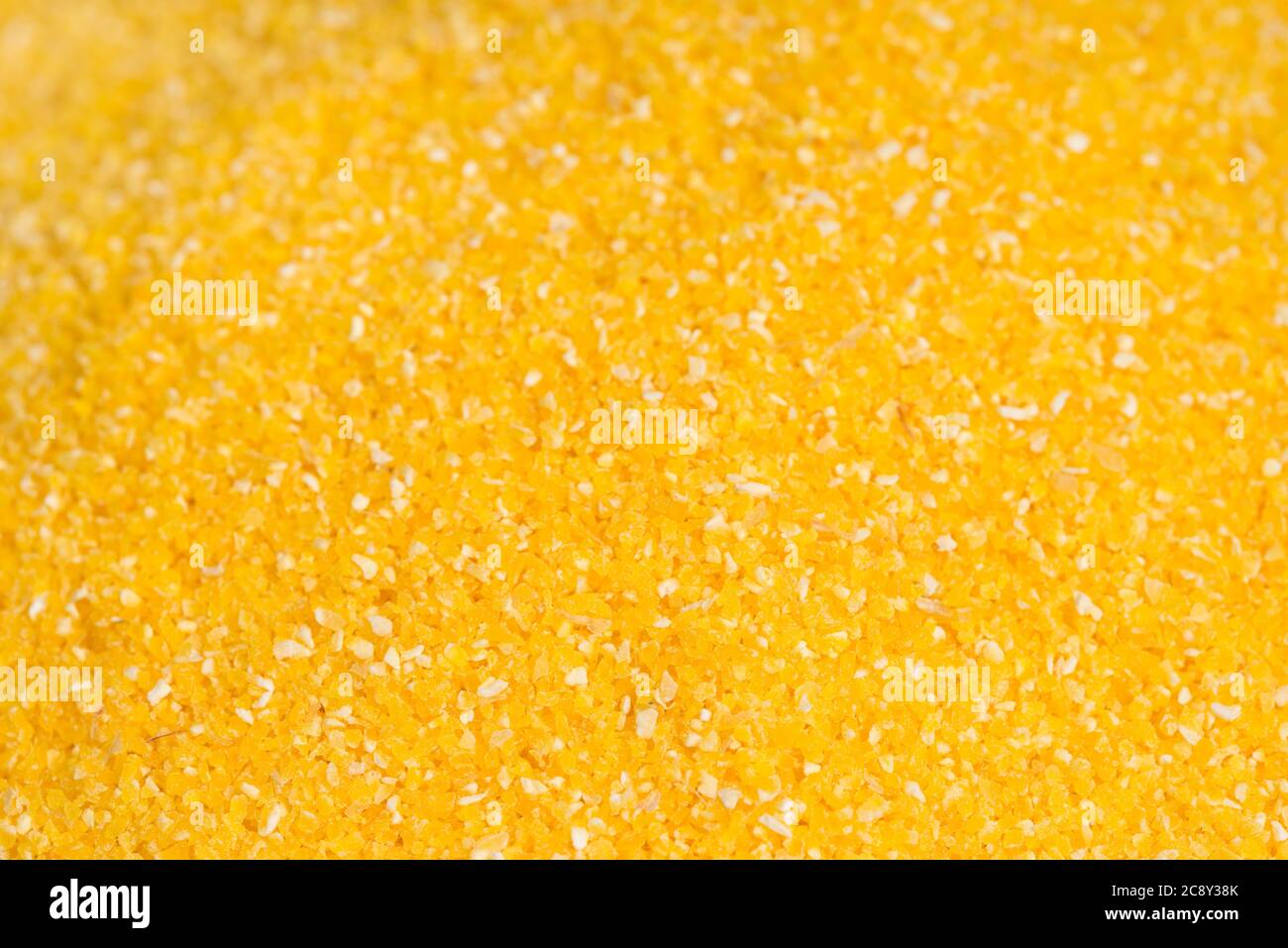 raw corn grits closeup selective focus background Stock Photo