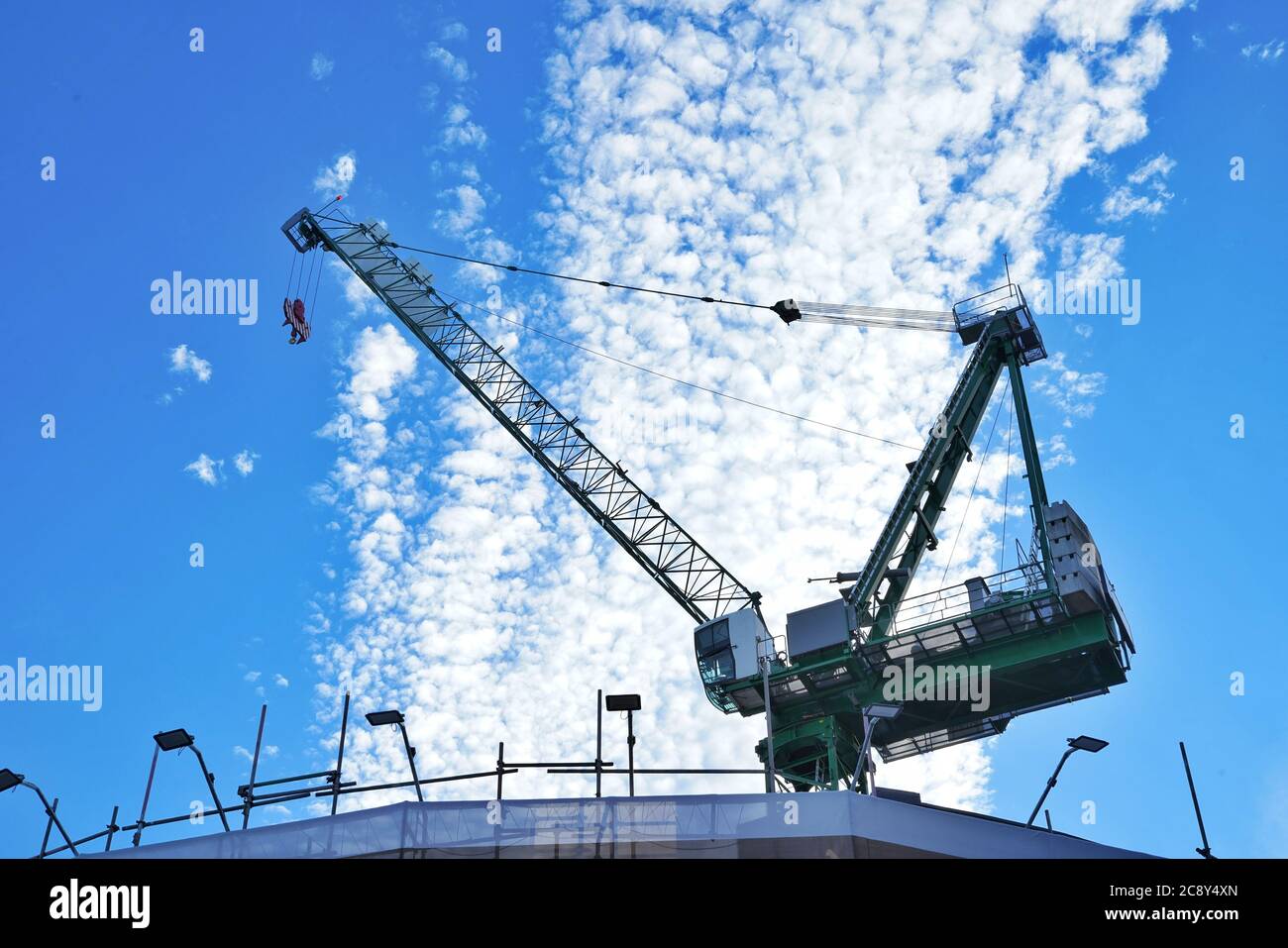 Construction crane on blue sky background with white clouds Stock Photo ...