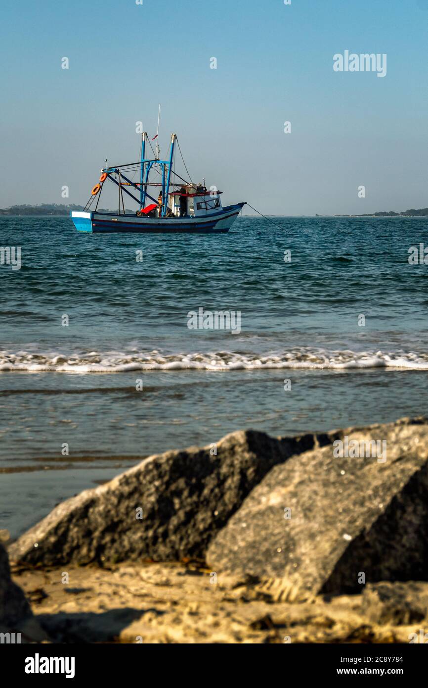 a small vessel looking to survive during the pandemic Stock Photo