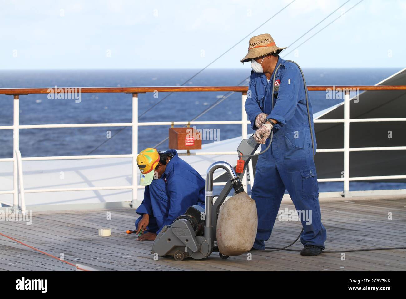 Sailors cleaning the deck of the ship hires stock photography and