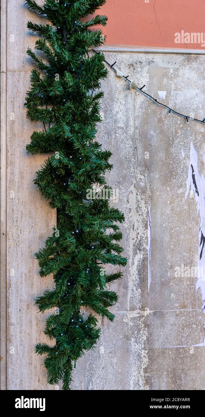 Christmas decoration on the wall of an apartment building, Christmas tree decorates the corner of the house Stock Photo