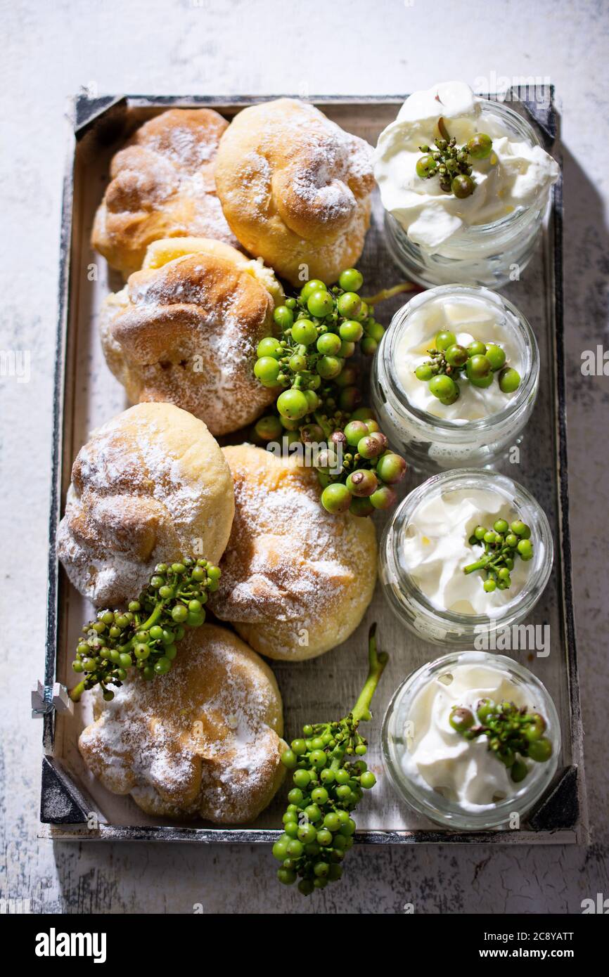 Sweet rolls with fruit and whipped cream in jars.Grape ornament.Healthy food and drink. Stock Photo