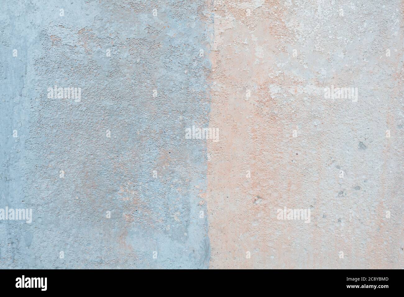 Colored pale concrete wall texture. Stucco painted in baby blue and peach colors Stock Photo