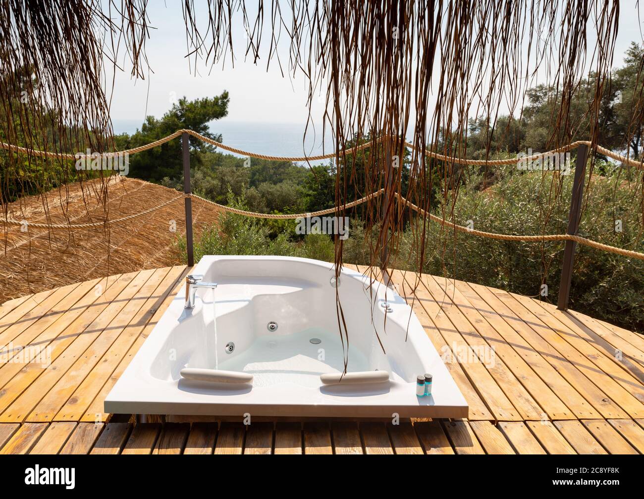 Hot tub in the hotel suite balcony with sea view.  Luxury honeymoon romantic resort vacation place. Stock Photo