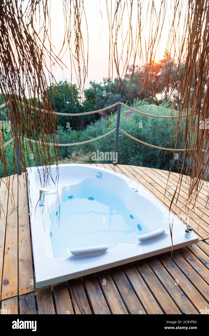 Hot tub in the hotel suite balcony with sea view.  Luxury honeymoon romantic resort vacation place. Stock Photo