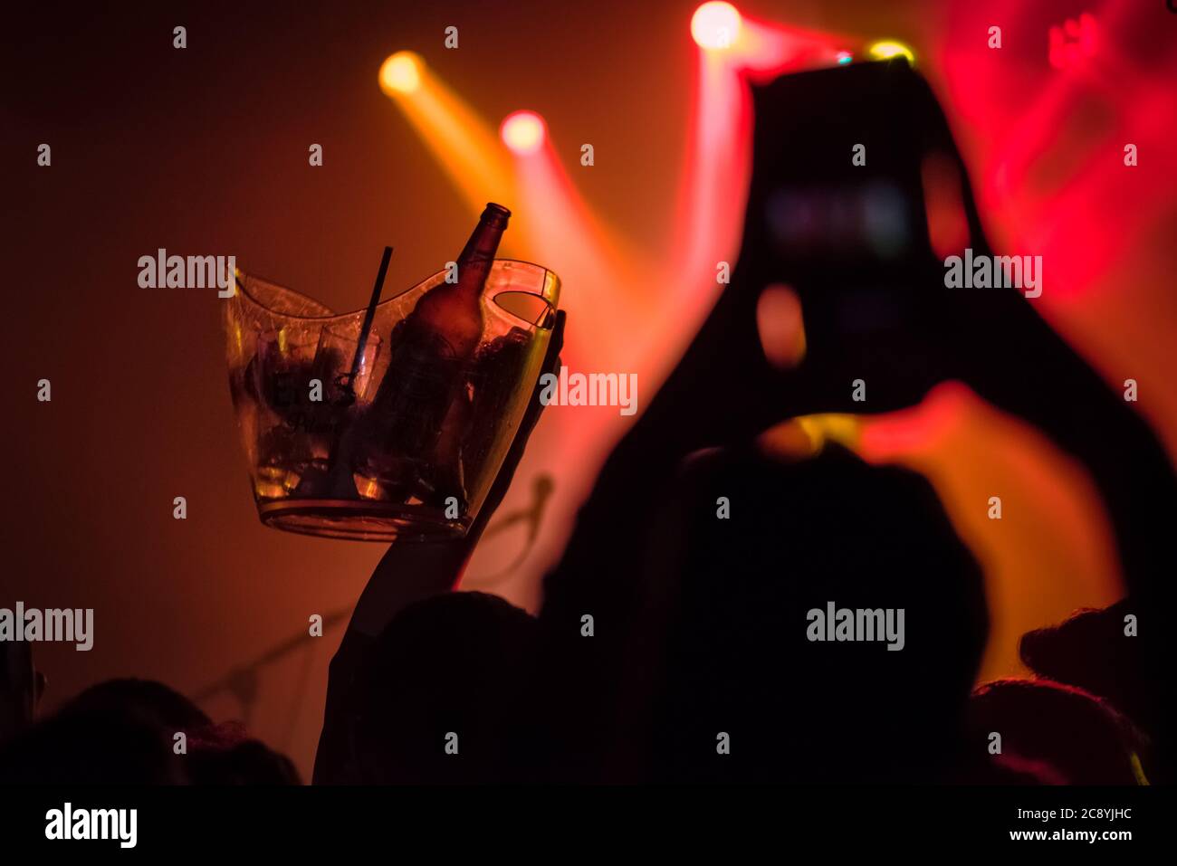 People at a pub are served beer and enjoy live music Stock Photo