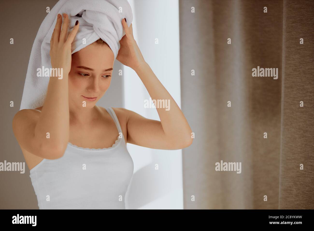 Nice pretty female looking down with thoughtful expression, keeping