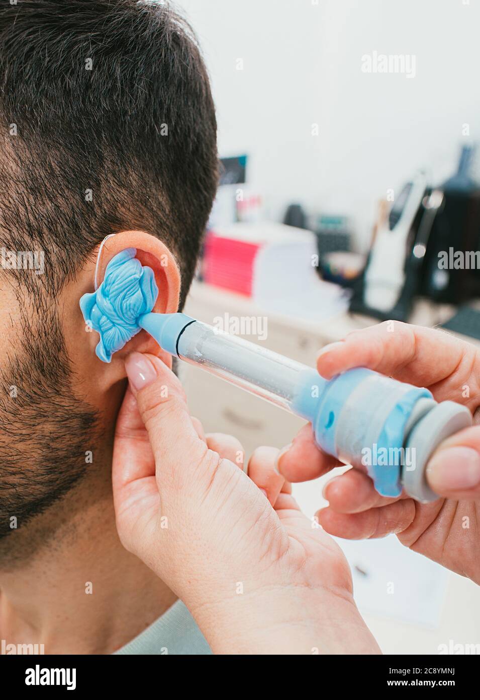 process of molded individual hearing aid earmolds. A man, having